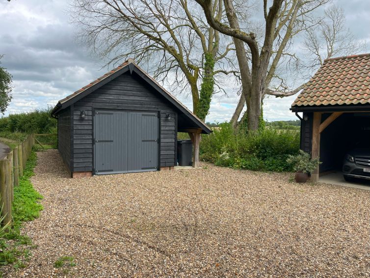 Driveway leading to a new 2-bay cartlodge and replacement workshop